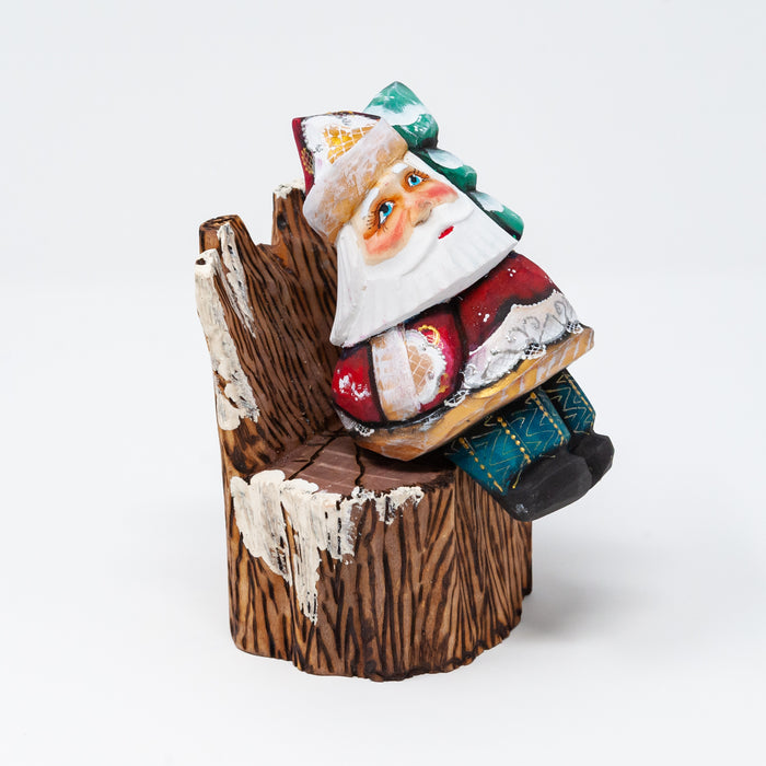 Hand-carved   Grandfather Frost sitting on Stump