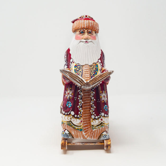 Hand-carved   Grandfather Frost in a Rocking Chair with a Book